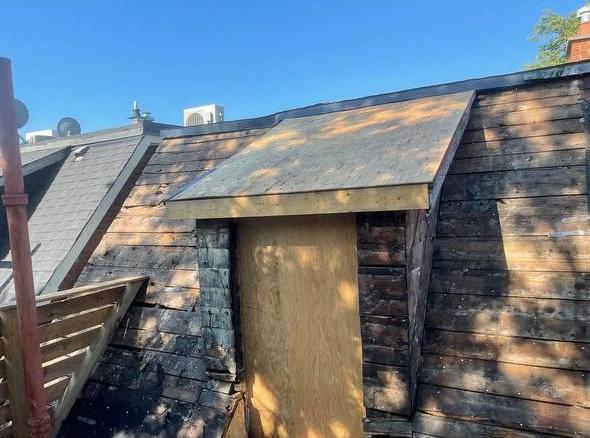 completed roof replacement around dormer with new shingles in Toronto