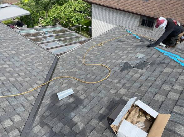 completed roof replacement with new shingles and skylight in Toronto