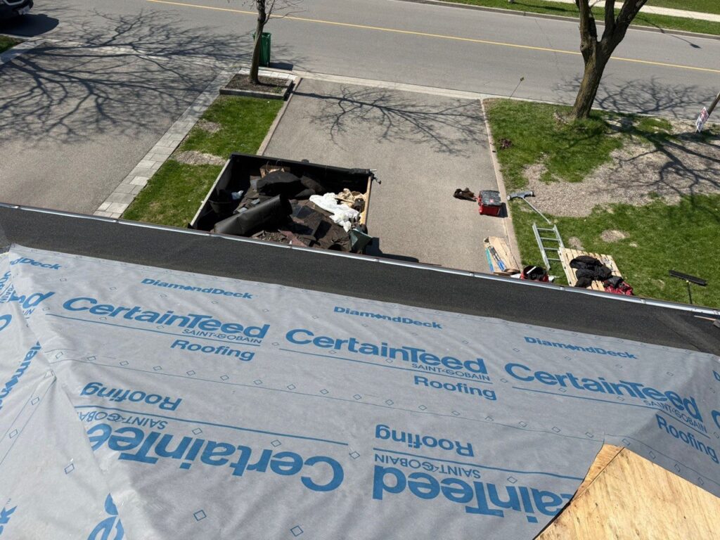 Old damaged roof in North York before roof replacement, showing worn shingles and roof preparation area before new installation.