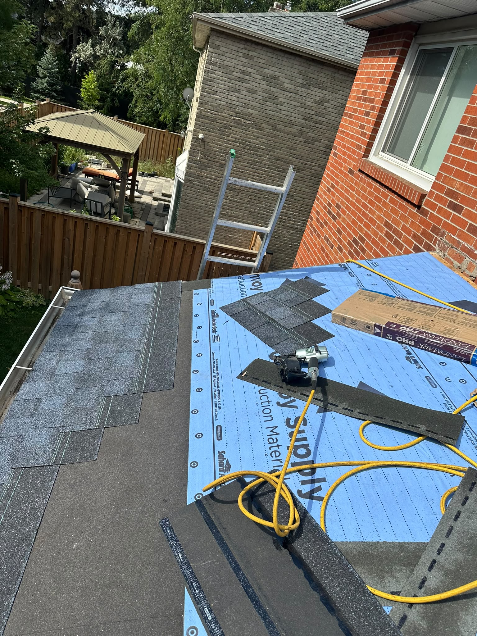Asphalt shingles being installed during a residential roof repair