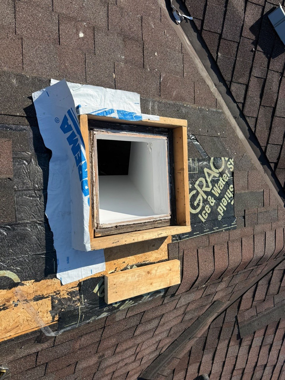 Skylight leak repair in progress on a shingle roof in Toronto